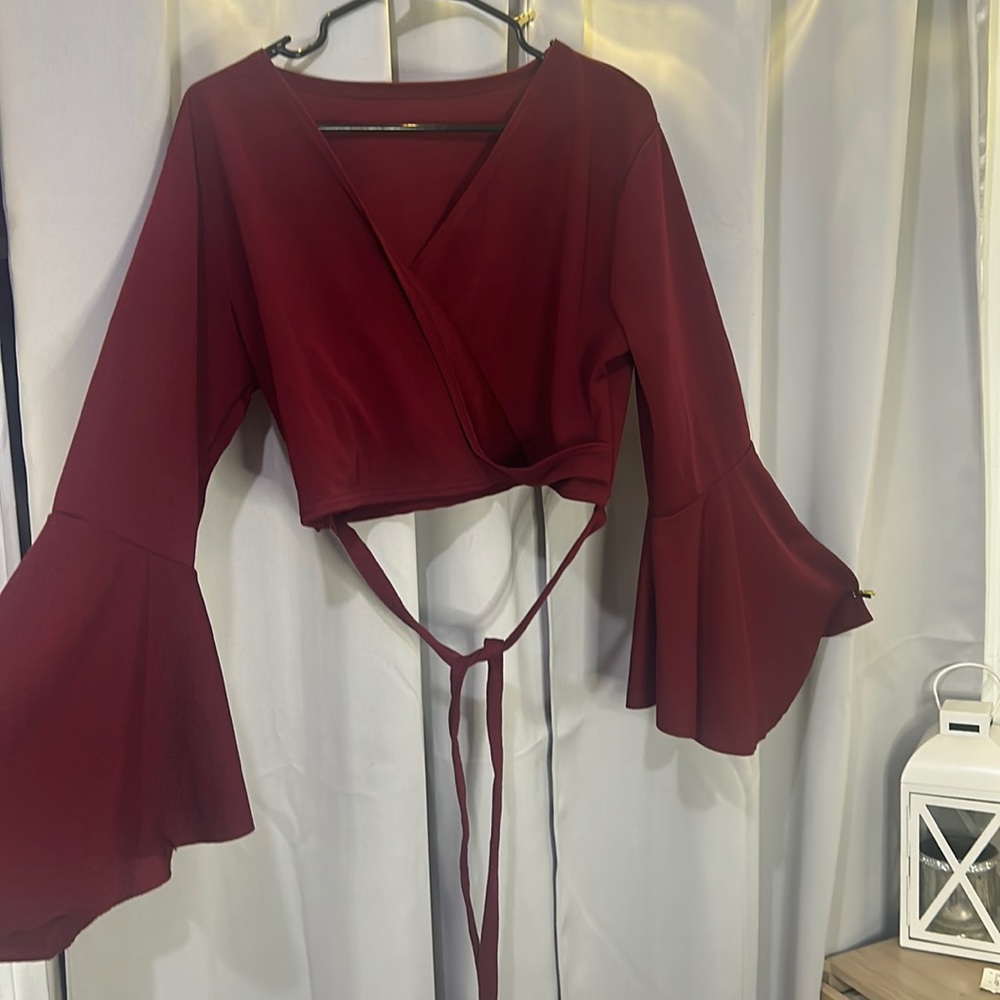 Classy top with a cross on the front side.